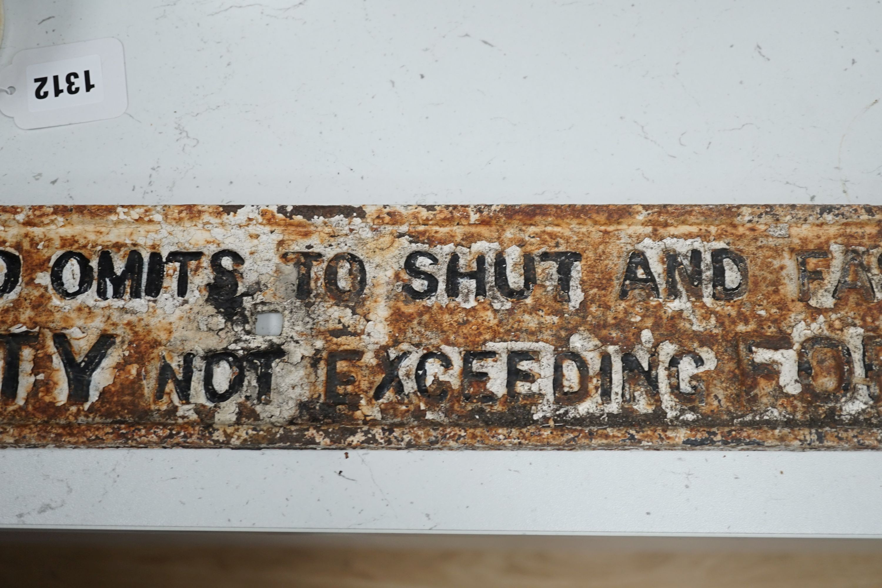 A cast iron gate sign, “any person who omits to shut and fasten this gate is liable to a penalty not exceeding forty shillings.”, 101 cms long.